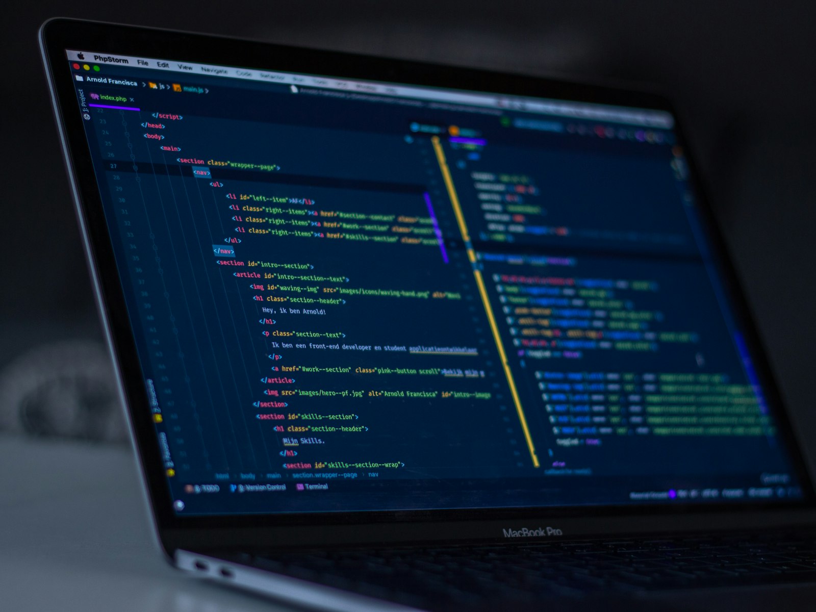 Laptop screen showing colorful code in a dark editor